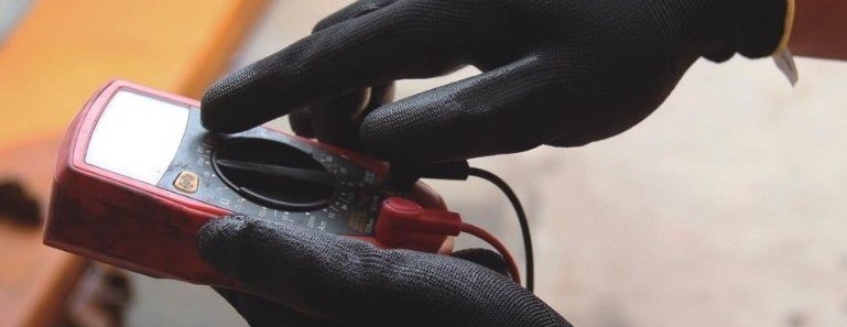 Technician using a multimeter