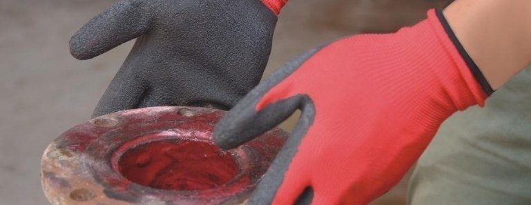 Gloved hands on a flange